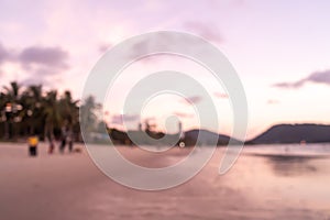 Blur tropical nature sea or beach in summer time with sunrise or sunset with light flare