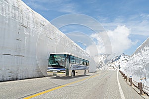 Blur windows bus move along snow wall at japan alps