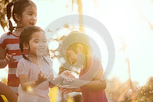 Blured image of asian children having fun to play with the rain