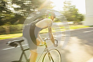 Young male cyclist riding a road bike in summer day. Action, motion concept