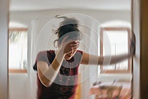 Blured photo of a woman suffering from vertigo or dizziness or other health problem of brain or inner ear