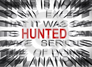 Blured text with focus on HUNTED photo