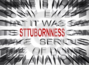 Blured text with focus on STUBBORNNESS photo
