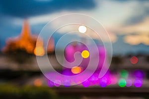 Blurred abstract background lights, beautiful fountain front of royal Thai temple.