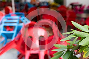 Blurred abstract background of outdoor cafe. Colourful tables and chairs in a cafe. Yellow, blue, red colors. Outdoor European