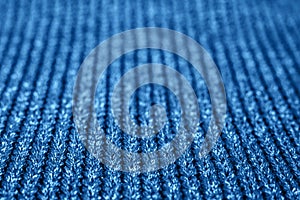 Blurred abstract background of trendy blue knitted fabric. Flat lay. Top view. Mockup for your design. Color of the year