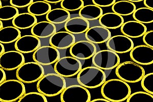 Blurred abstract background of yellow cardboard rings. Abstract blurry texture background.