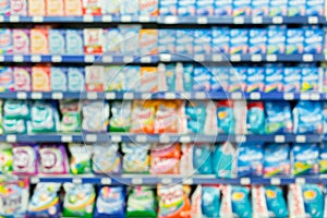 Blurred abstract bleach, fabric softener, laundry detergent, all purpose cleaners shelves in modern grocery retail store