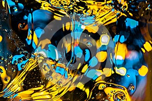 Blurred abstract fluid background with flowing big bubbles and bokeh lights of blue, cyan and yellow color. mysterious backdrop