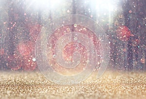 Blurred abstract photo of light burst among trees and glitter bokeh lights. filtered image and textured