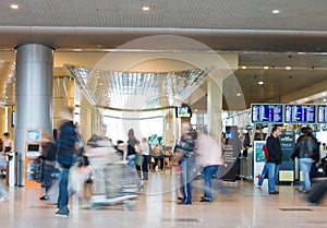 Blurred advancing people in airport installations