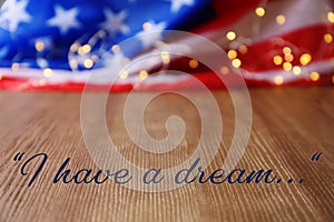 Blurred American flag and garland on wooden table.