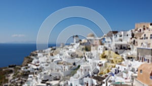 Blurred of Architecture with windmills on a hillside in Oia village on Santorini island, Greece Mediterranean sea