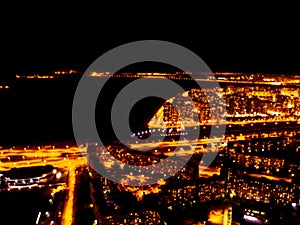 Blurred background Aerial night view of a big city. Cityscape panorama bokeh at night. Blurry Aerial view of skyscraper and road w