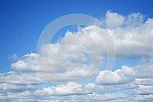 Blurred background. Blue sky and white fluffy clouds