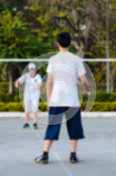 Blurred background : boy and girl playing badminton