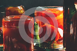 Blurred background with canned tomatoes and cucumbers