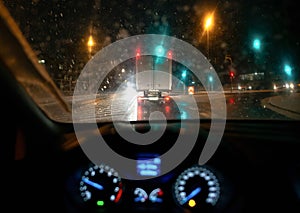 Blurred background. City view, lights, falling snow, night, street, bokeh spots moving cars winter scenery Lantern light