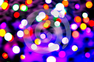 Blurred background with colorful bokeh lights on dark purple and blue background/blurred Christmas lights