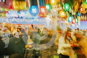 Blurred background of crowd of people on city, Christmas holidays. Evening, neon lights, city Christmas decoration