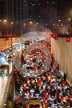 Blurred background of crowd of Vietnamese football fans down the street to celebrate the win after soccer, with a lot of