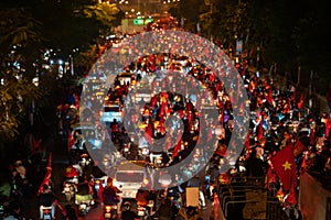 Blurred background of crowd of Vietnamese football fans down the street to celebrate the win after soccer, with a lot of