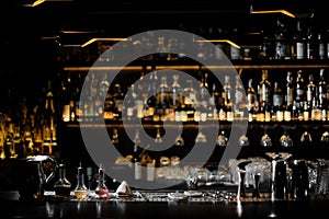 Blurred background of dark bar with barman essentials