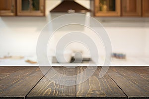 Blurred background. Empty wooden tabletop and defocused modern kitchen for display or montage your products.