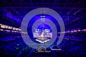 Blurred background of an esports event - Big illuminated main stage of a computer games tournament located on a big