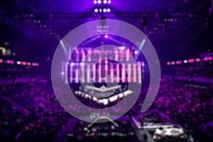 Blurred background of an esports event - main stage venue, big screen and lights before the start of the tournament. photo