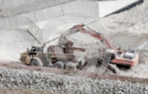 Blurred background of excavator loading material to dump truck