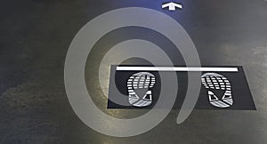 Blurred background of footprints and forward arrow on the floor