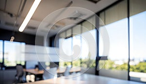 Blurred Background of a Light Modern Office with Panoramic Windows and Beautiful Lighting