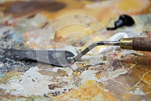 Blurred background of painting palette and spatula