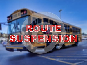 Blurred background of a school bus with the words Route Suspension in the foreground