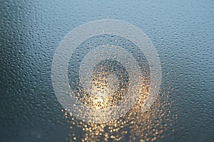 Blurred background when see through car windshield with full droplets