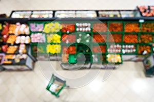 Blurred background of a supermarket in the department of fruits and vegetables