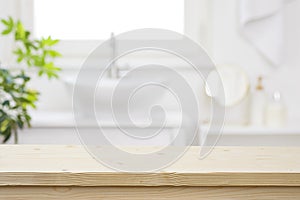 Blurred bathroom hand washing corner with wooden table in front