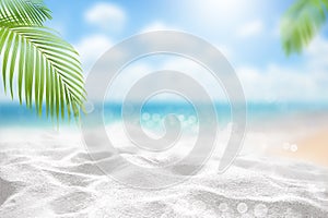 Blurred beautiful tropical ocean and white sand beach with bokeh of sea wave and green palm leave summer background