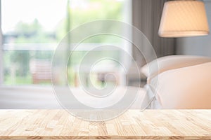 Blurred bedroom interior background and wooden table top in front  for montage or display your products