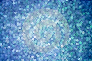 Blurred blue festive background with shining circles.
