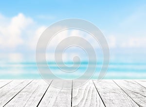 Blurred blue sky and sea with bokeh light and leaves of coconut palm tree