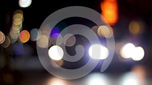 Blurred bokeh of car, traffic and street light at city night, defocused colorful lights on street concept