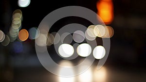 Blurred bokeh of car, traffic and street light at city night, defocused colorful lights on street concept