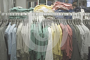 Blurred Bokeh Image of a Retail Clothing Store with hanging apparel for background