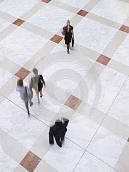 Blurred Business People Walking On Tiled Floor