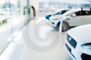 blurred car showroom with new and