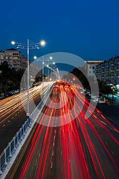 Blurred car traffic light at night city. Traffic jam in evening rush hour.