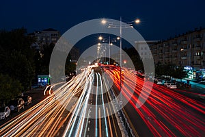 Blurred car traffic light at night city. Traffic jam in evening rush hour.