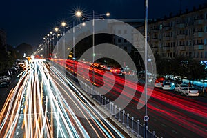 Blurred car traffic light at night city. Traffic jam in evening rush hour.